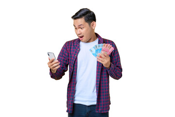 Shocked young Asian man in plaid shirt using mobile phone and holding money banknotes isolated on transparent background