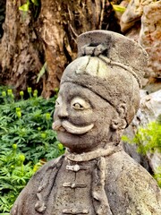 Ornate Stone Statue Head with Traditional Headdress