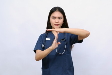 Female doctor, on a white background, shows a pause sign,serious and stop gesture
