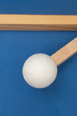Still life with wooden blocks and a a plastic foam ball on blue background	