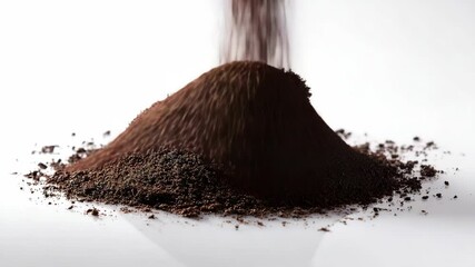 Pouring dark brown powder creating a mound on a white surface, granular material falling and accumulating in a heap, closeup shot. - Powered by Adobe