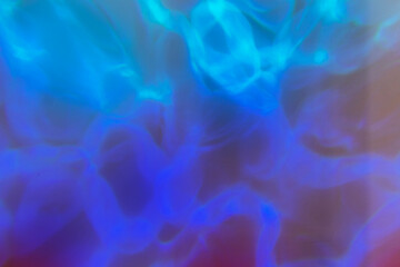 Abstract painting, colorful reflections in the form of ocean waves on a wall.