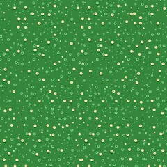 Colorful polka dot seamless pattern with a green background for textiles or wallpapers at a craft space