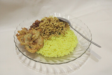A plate of yellow rice with side dishes. delicious yellow rice food