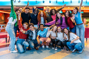 Happy multiethnic friends enjoying bowling alley games