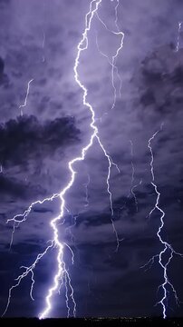 video of Dramatic lightning strikes illuminate stormy night sky explosive flashes billowing clouds emphasizing power nature action