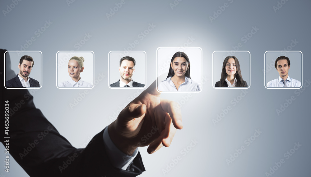 Poster Business hand selecting candidate profile from digital interface with multiple portraits of professionals on light abstract background.