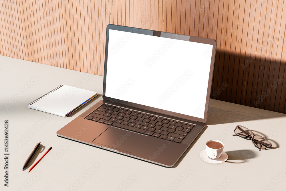 Poster laptop with blank screen on modern office desk with coffee, notebook, and glasses in sunlight and sh