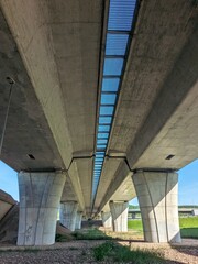 Panoramic industrial scene showing infrastructure and empty space beneath highway bridges on a...
