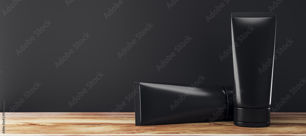 Poster black cosmetic tubes on wooden tabletop with dark wall background for branding and product presentat