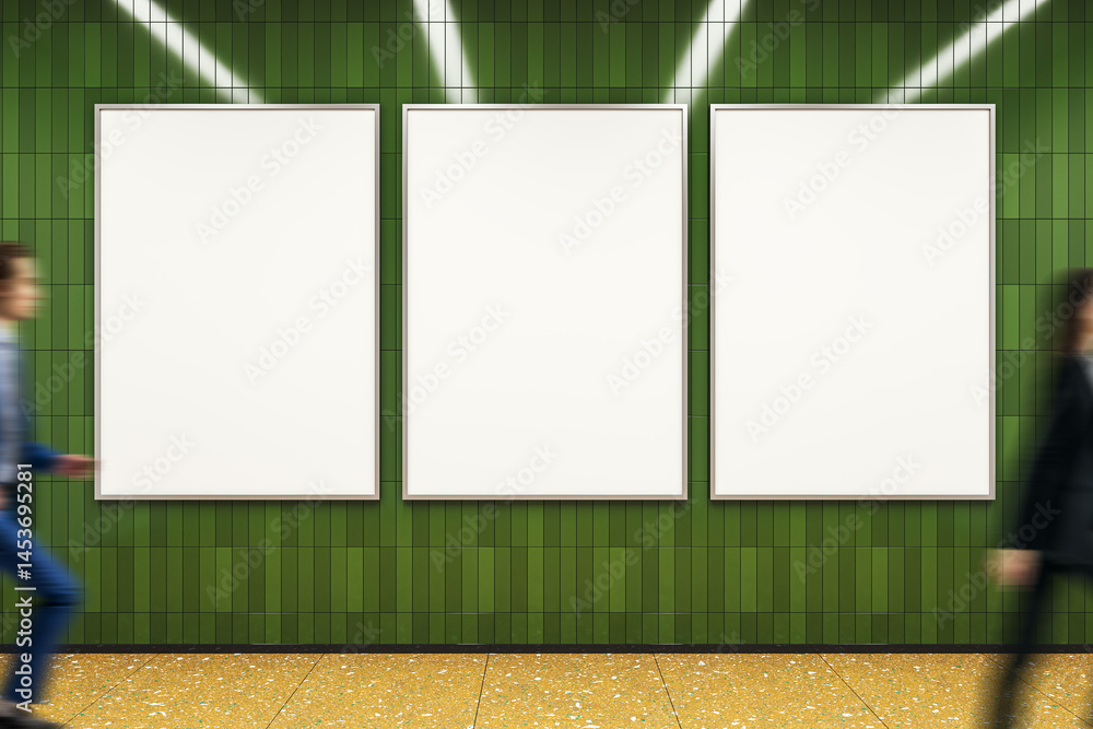 Aufkleber three vertical blank posters on green tiled wall with two blurred people walking by in corridor or h