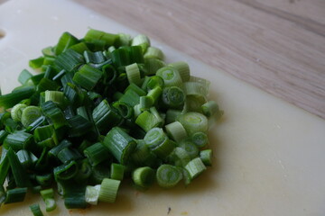 Sliced fresh onions on a board on the kitchen counter.