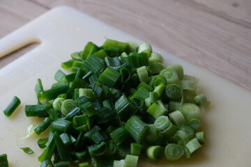 Sliced fresh onions on a board on the kitchen counter.