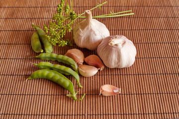 fresh vegetables on the table. garlic, green peas, dill.