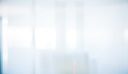 Abstract blurred background with white and light blue tones creating a soft effect.