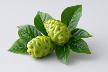 Obraz premium Noni Fruit with Green Leaf