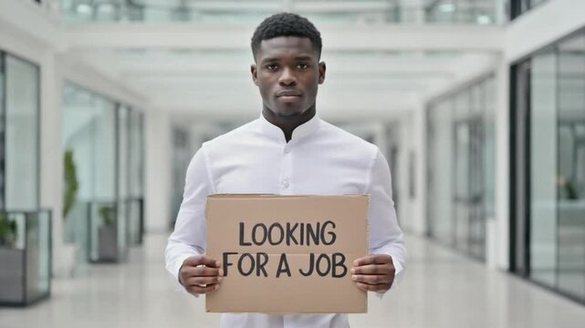 Blackman holding a sold sign in LOOKING FOR A JOB