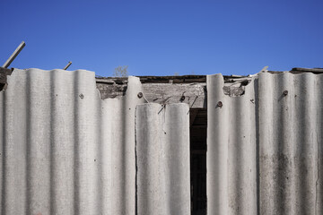 Old and very dangerous asbestos roof. Asbestos dust in the environment. Asbestos removal