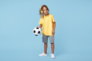 Full length image of cute little boy with african dreads playing with soccer ball