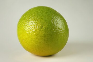 Fresh green lime on a plain background, showcasing its texture and color for culinary use