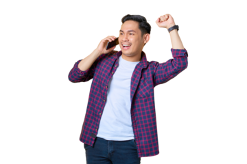 Excited young Asian man in plaid shirt talking on mobile phone and doing winner gesture isolated on transparent background