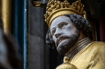 Nuremberg, Germany, August 2, 2023. Detail of one of the many statues that characterize the golden fountain in the market square. Travel destinations and tourist attractions.