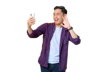 Cheerful young Asian man in plaid shirt doing selfie shot on mobile phone waving hand isolated on transparent background