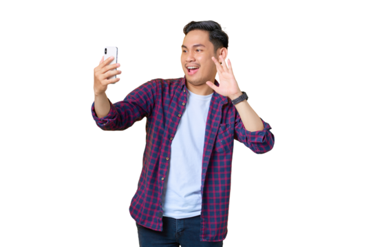Cheerful young Asian man in plaid shirt doing selfie shot on mobile phone waving hand isolated on transparent background - Powered by Adobe