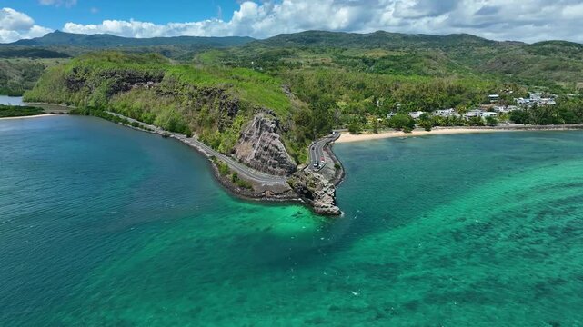 Aerial view of the emerald Indian Ocean meeting cliffs and coastal curves at the famous Maconde Viewpoint, Mauritius