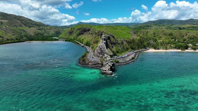 Aerial view of the emerald Indian Ocean meeting cliffs and coastal curves at the famous Maconde Viewpoint, Mauritius