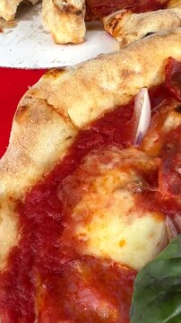 Indulge in a mouthwatering slice of delicious pizza topped with fresh basil and other toppings