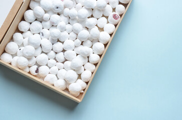 Fresh Cranberries in sugar in a box. Blue background.