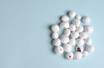 Fresh cranberries in sugar. Blue background.