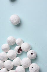 Cranberries coated with white sugar. Blue background.