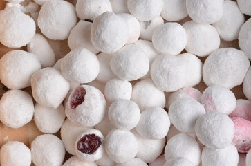 Cranberries in sugar close-up. Beige background.