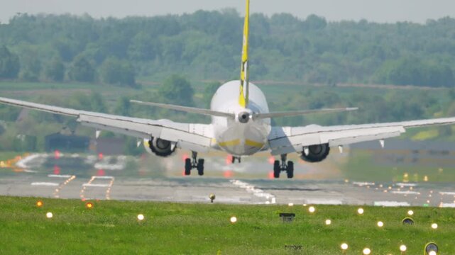 Majestic aircraft descends gracefully onto the runway, capturing the essence of air travel and adventurous vacations
