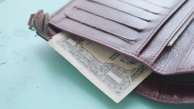 money in a leather wallet