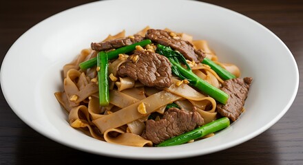 Pad See Ew with beef and Chinese broccoli in a white bowl