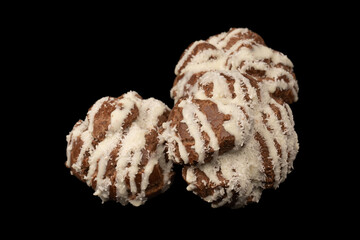 Profiteroles with coconut cream on a black background.
