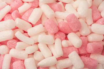 Pink and white box filler as a background. Top view.