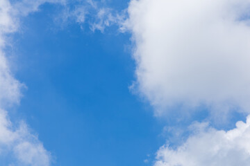 Obraz premium Bright blue sky with fluffy white clouds.