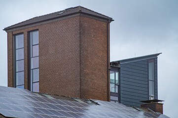 Photovoltaic panels generating green energy on rooftop of modern building
