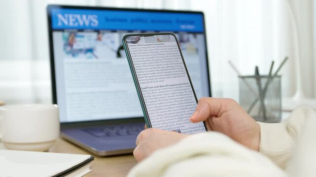 News on the phone and computer screen. Viewing information on the gadget. Press online.