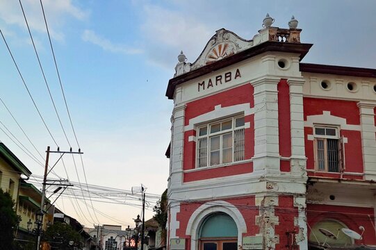 Gedung Marba is a heritage building in Semarang's Old Town with Renaissance-influenced style and light red-painted exposed stonework.