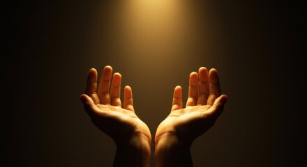Two cupped hands reaching upwards against a dark background. A soft warm golden light emanates from above, gently illuminating the hands.