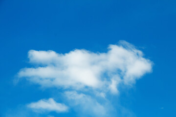 White cloud in bright blue sky. Natural picturesque background