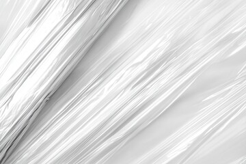 Shiny, crinkled plastic wrap creating an abstract background with smooth, reflective surfaces
