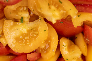 preparation of salad from sliced tomatoes with spices and oil