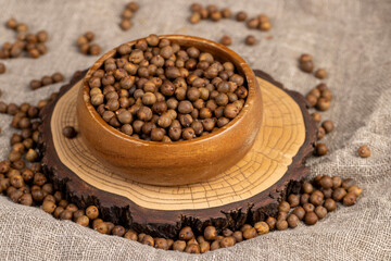 Roasted chickpeas are scattered on the table, but not boiled chickpeas are on the table with a tablecloth