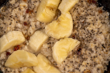 pieces of ripe banana and oatmeal porridge, boiled oatmeal porridge with chia